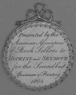 Inscribed silver medal with decorative border and silver bow.